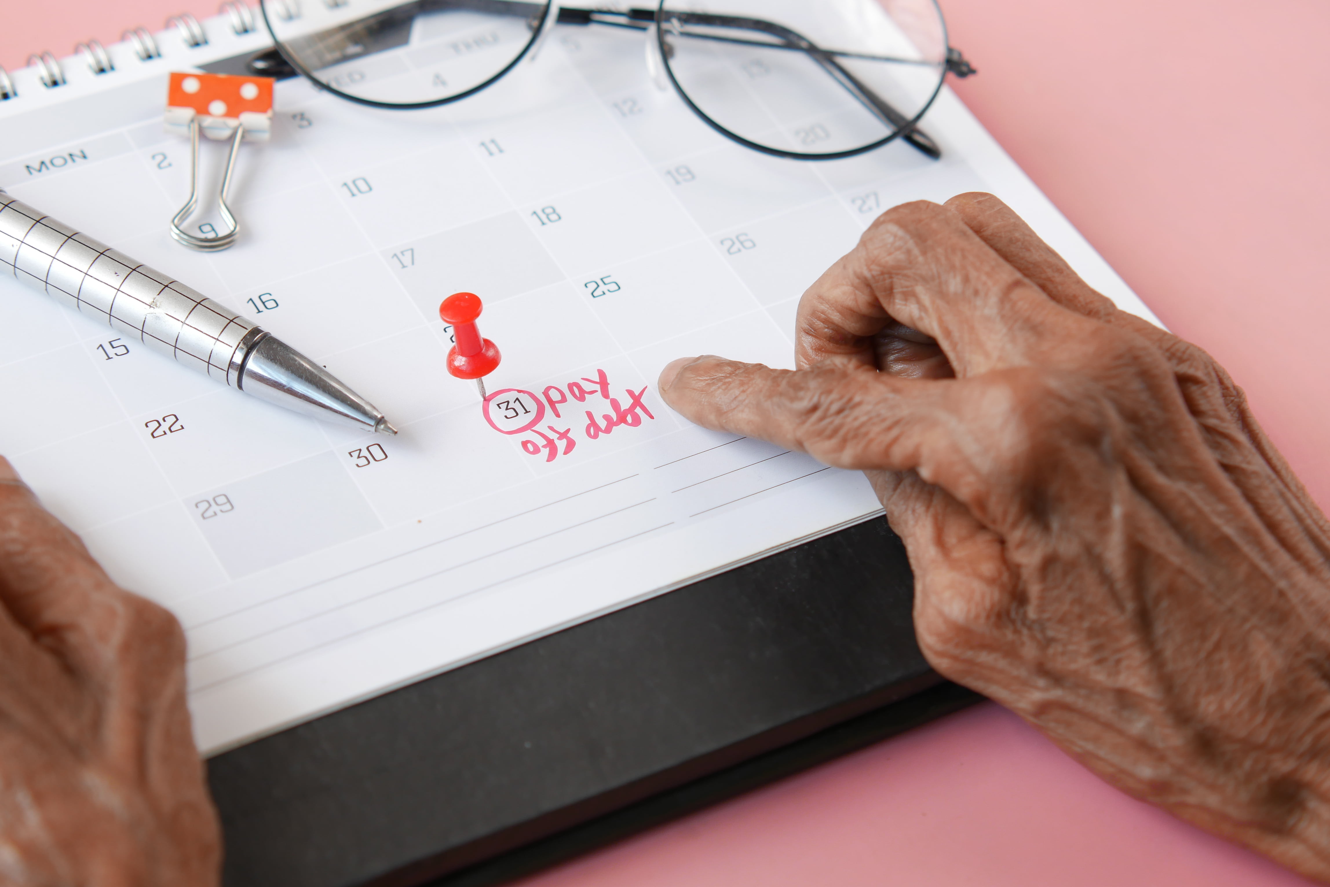 Close up of pay debt word on calendar