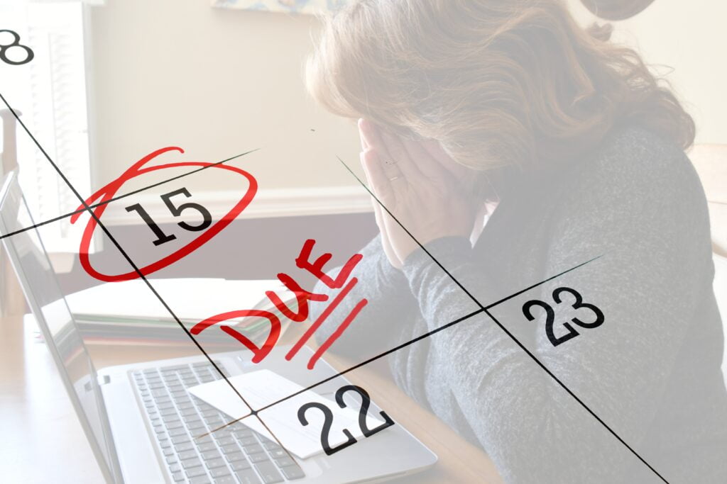 Female dealing with stress of deadline for work, paying bills taxes, submitting project