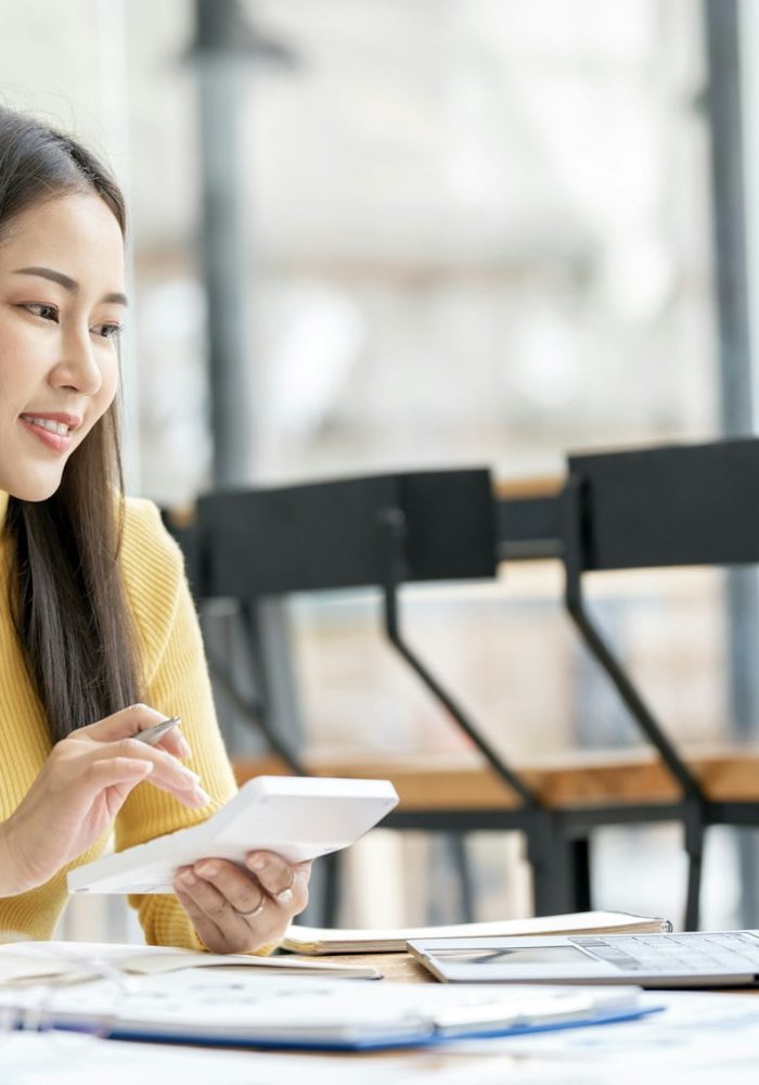 Businesswoman working Financial investment on calculator, Economic, commercial concept.