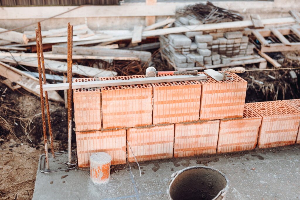 industrial bricklayer installing bricks on construction site